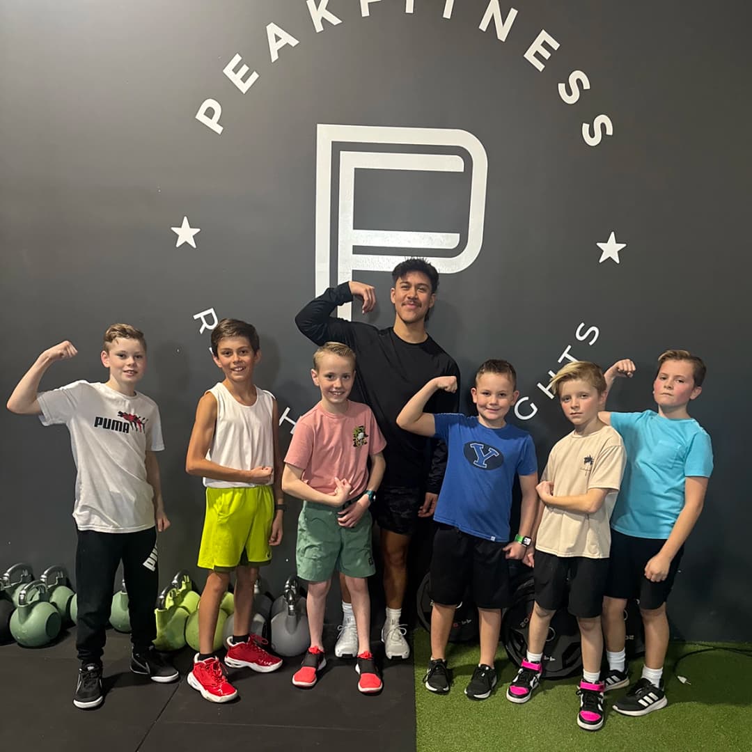 Peak Fitness youth athletes with their coach