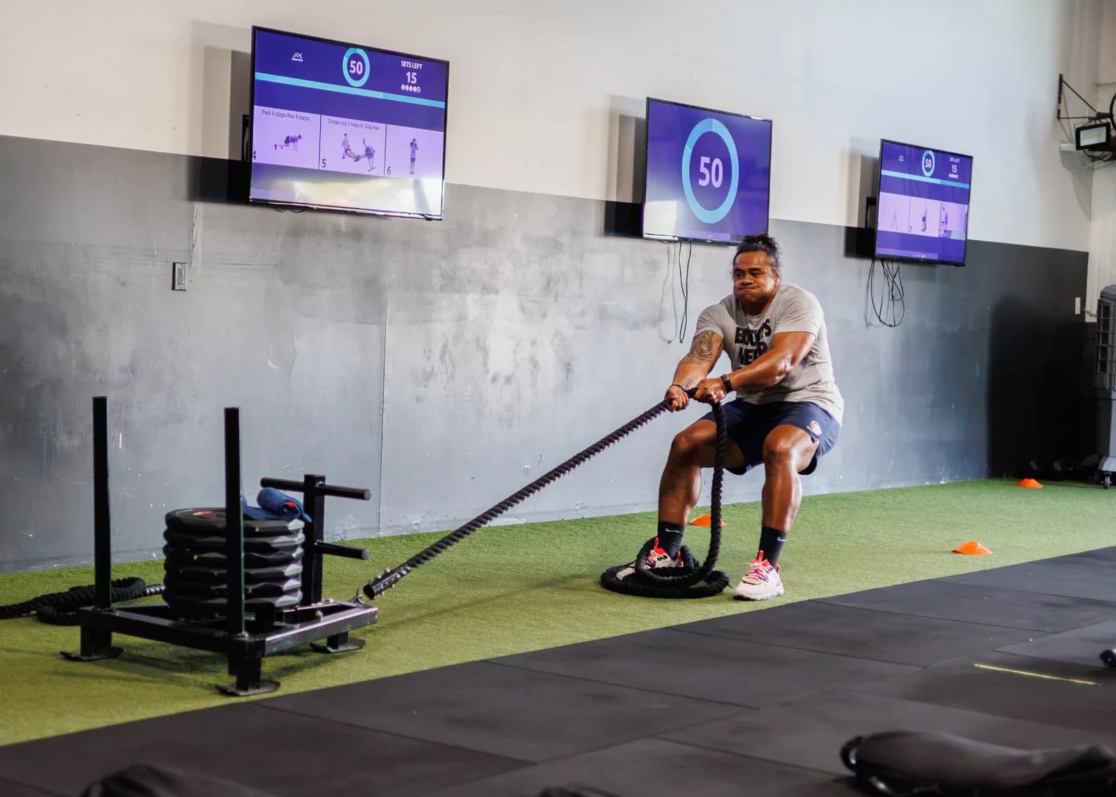 Member doing a HYROX-style sled rope pull at Peak Fitness in Orem